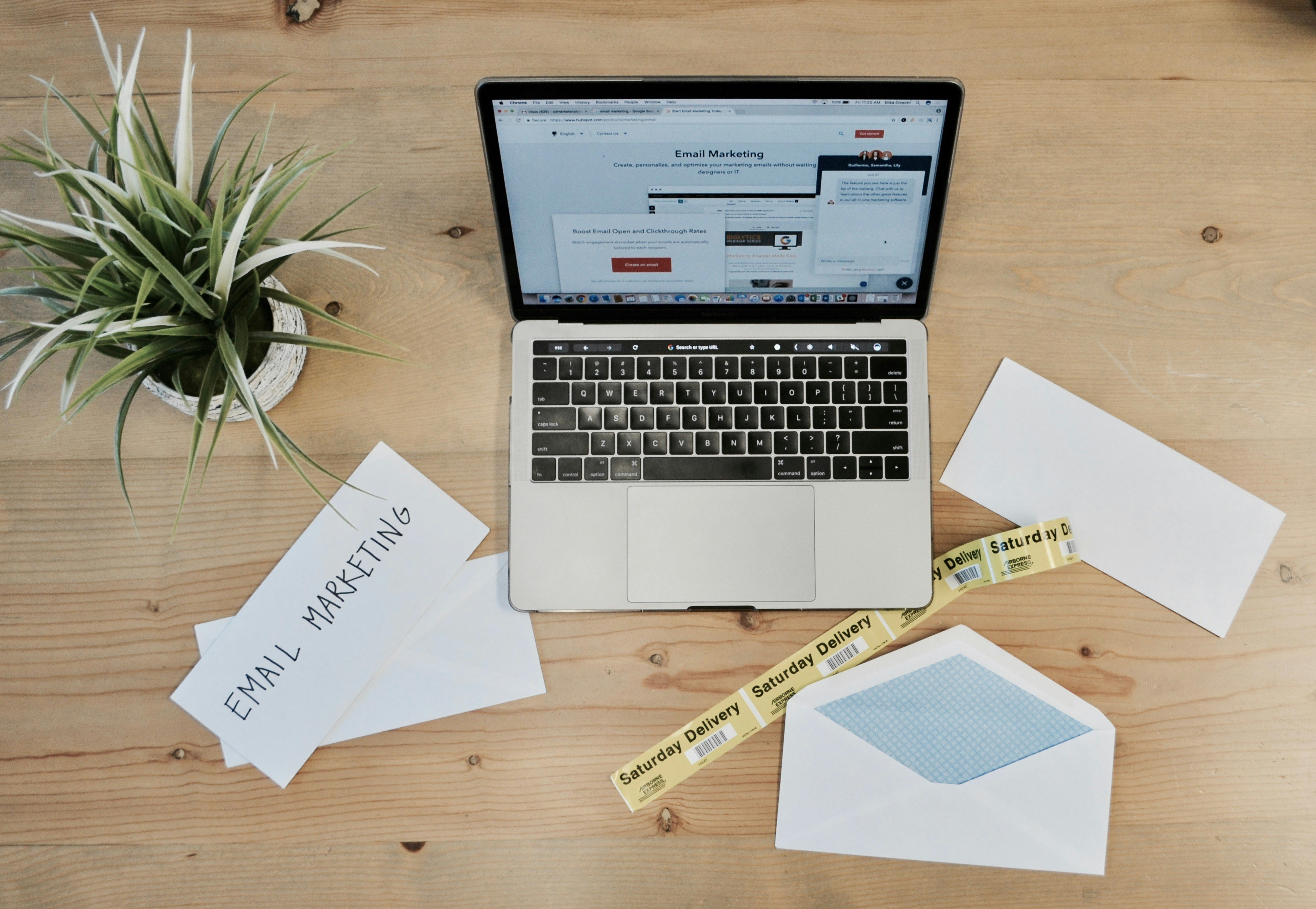 A clean desk workspace with a laptop showing a website design